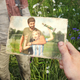 Joel holds a photograph of himself with his daughter Sarah at a soccer game from the game The Last of Us.